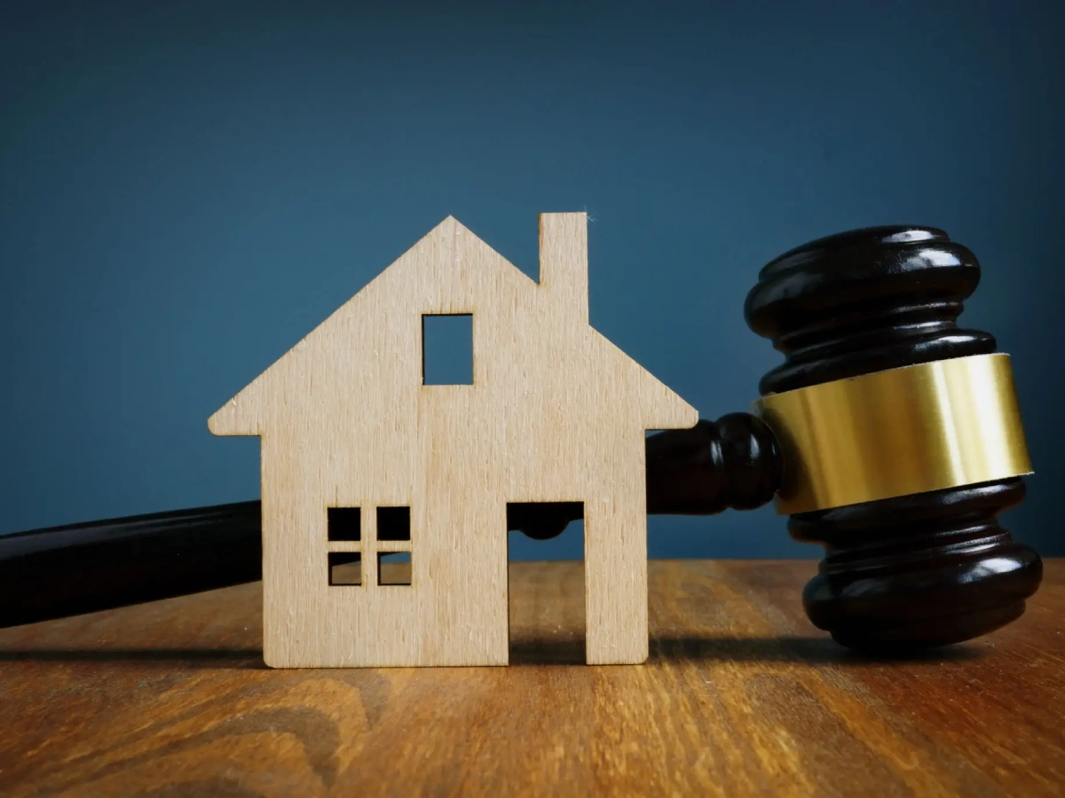 House model and gavel on table