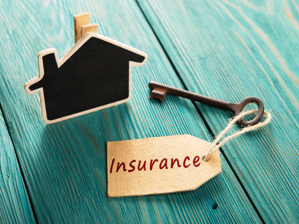 Wooden house, old key, insurance label.