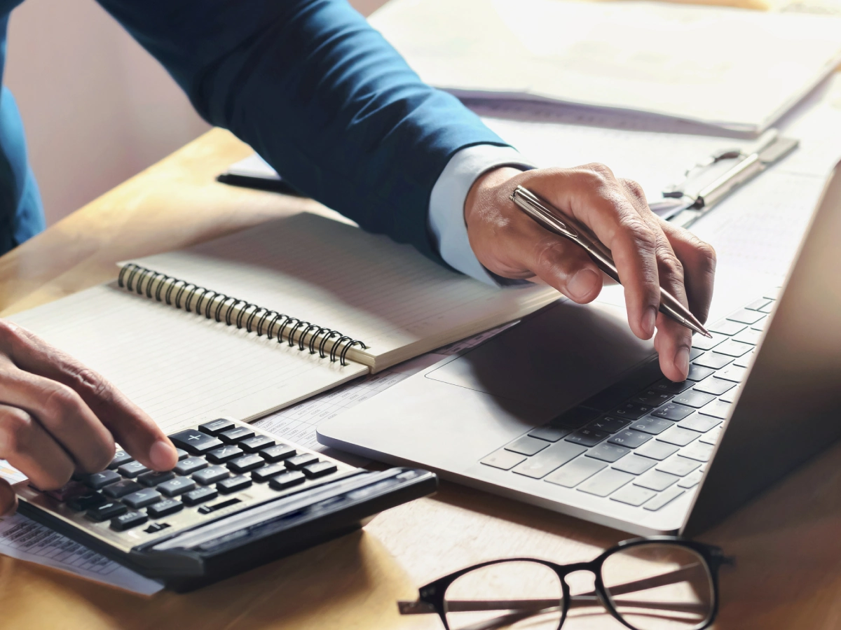 Man calculating finances at desk