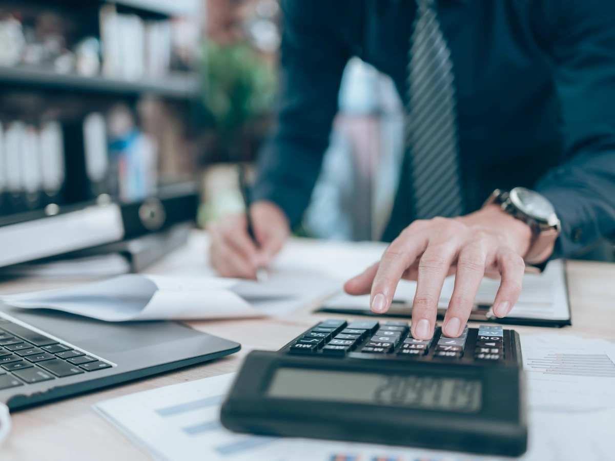 Office worker with calculator and documents