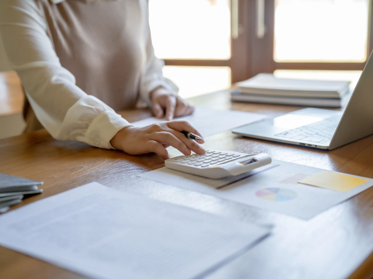 Hands calculating finances at desk