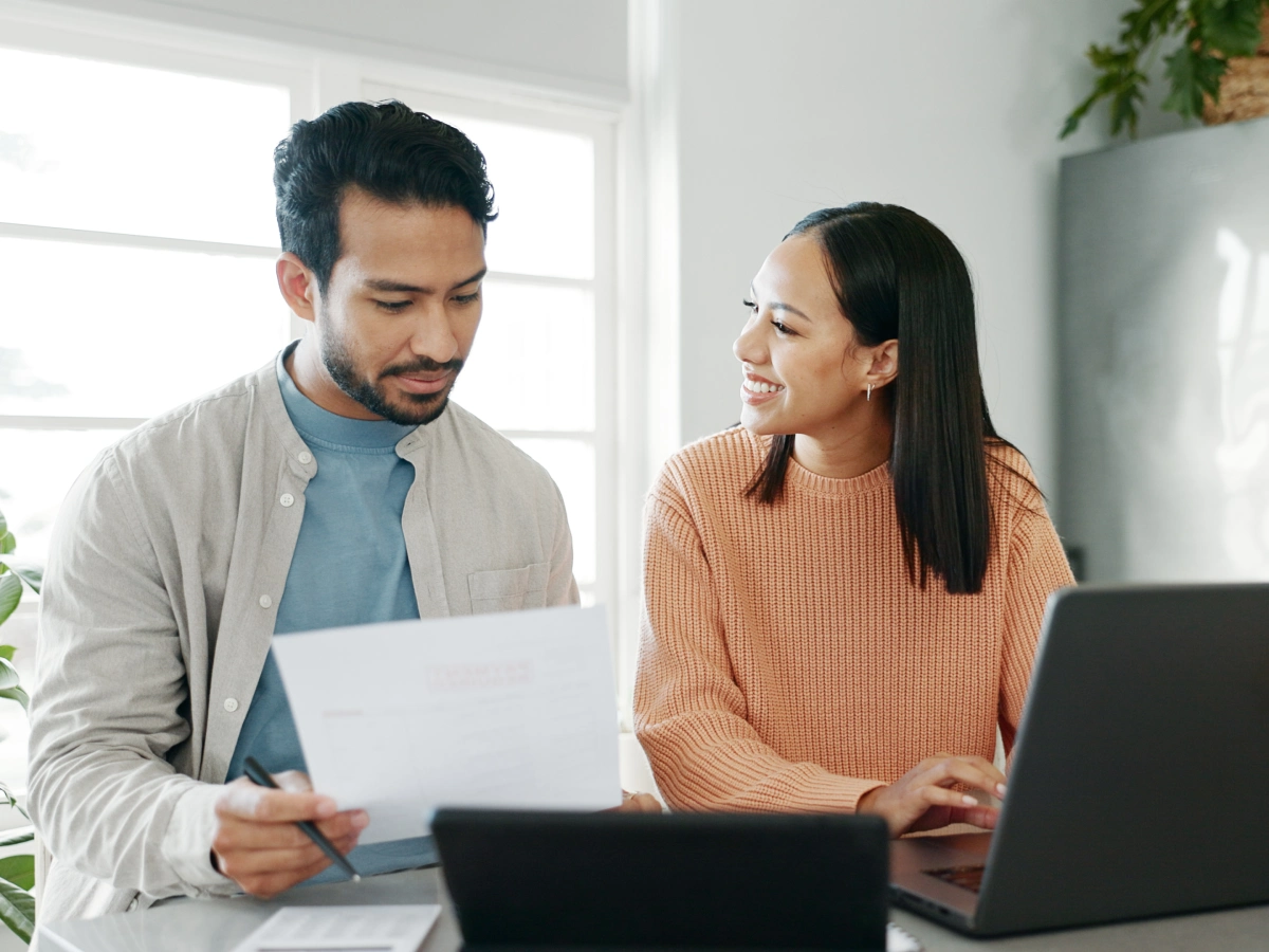 Couple reviewing documents at home office