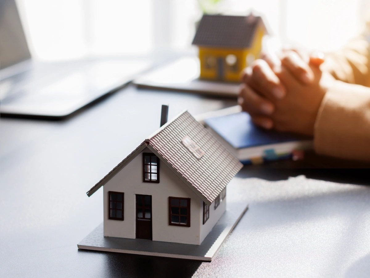 Real estate concept with miniature house