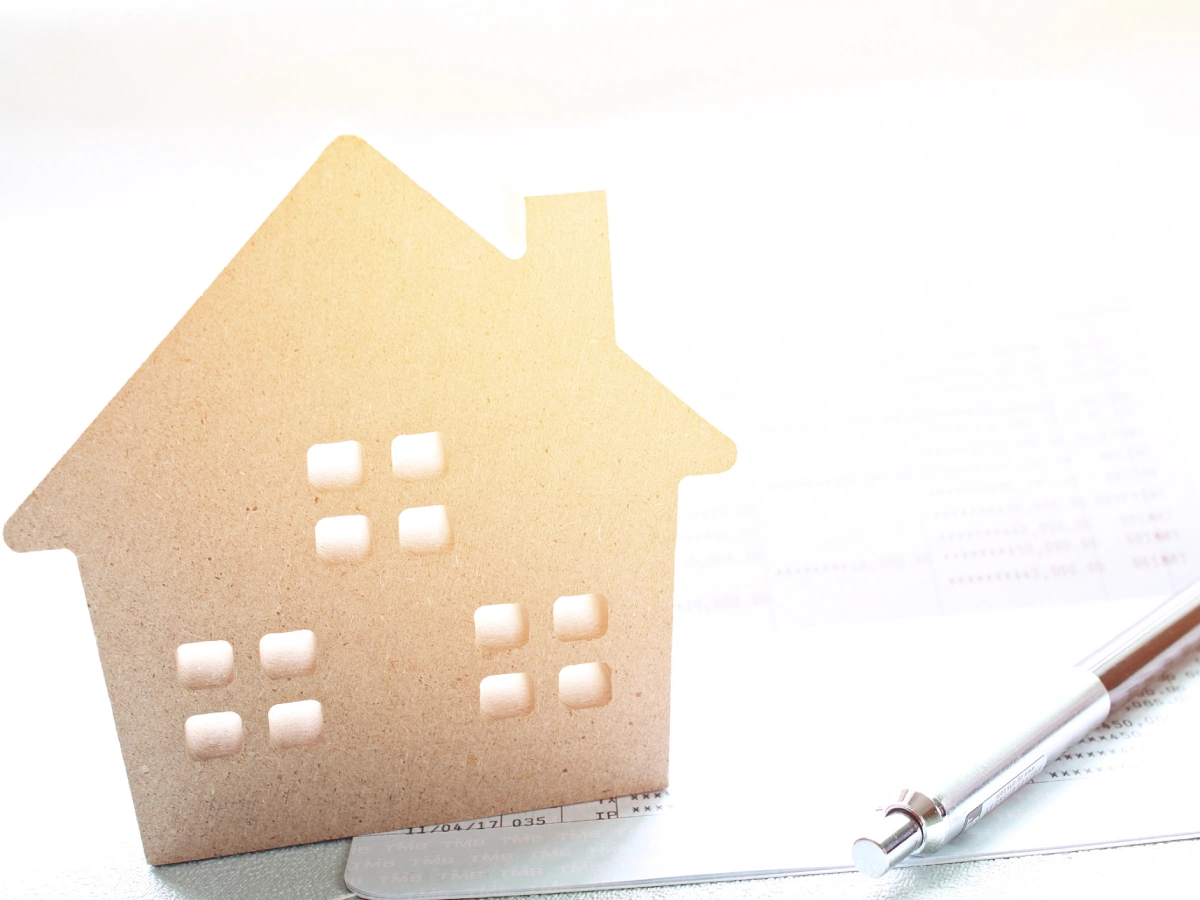 Symbolic house on financial documents