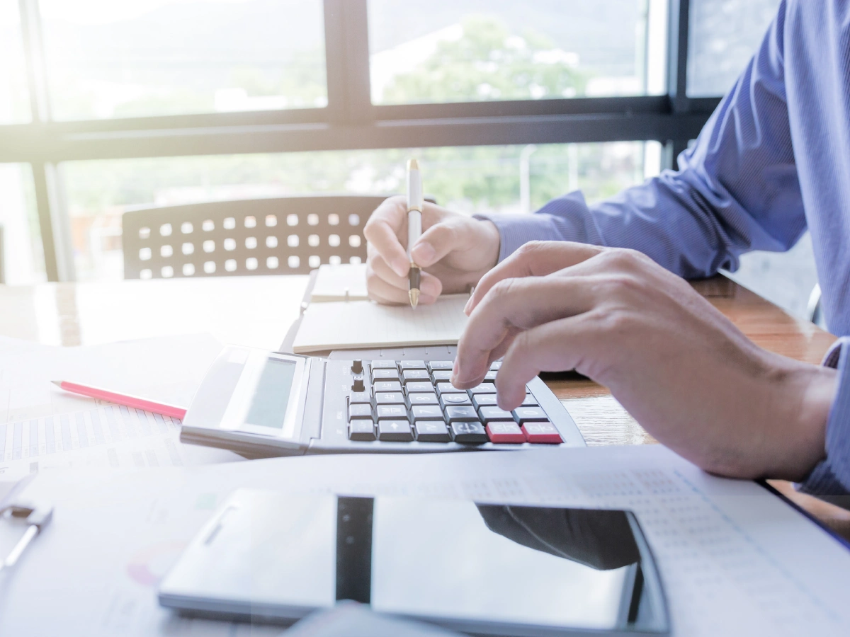Office desk with calculator and smartphone