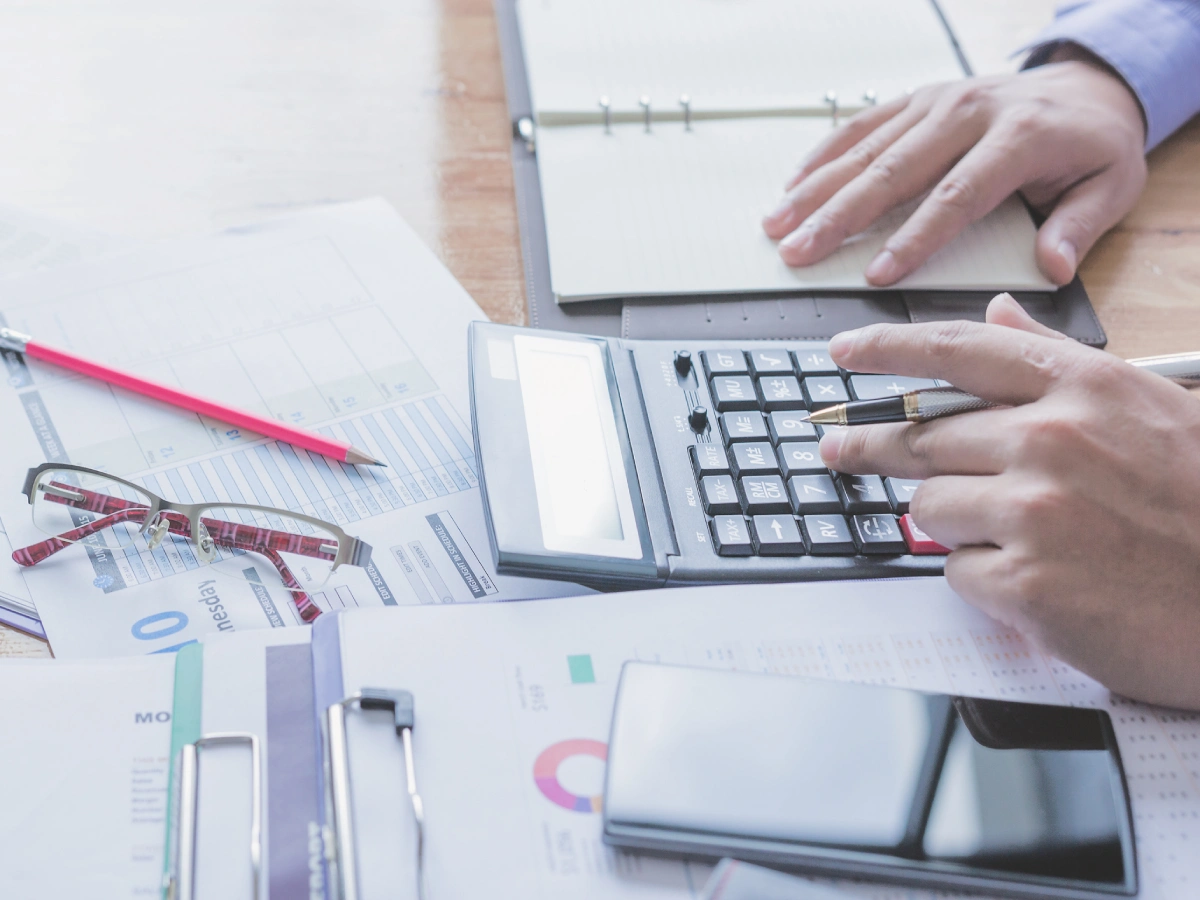 Desk with financial documents and calculator